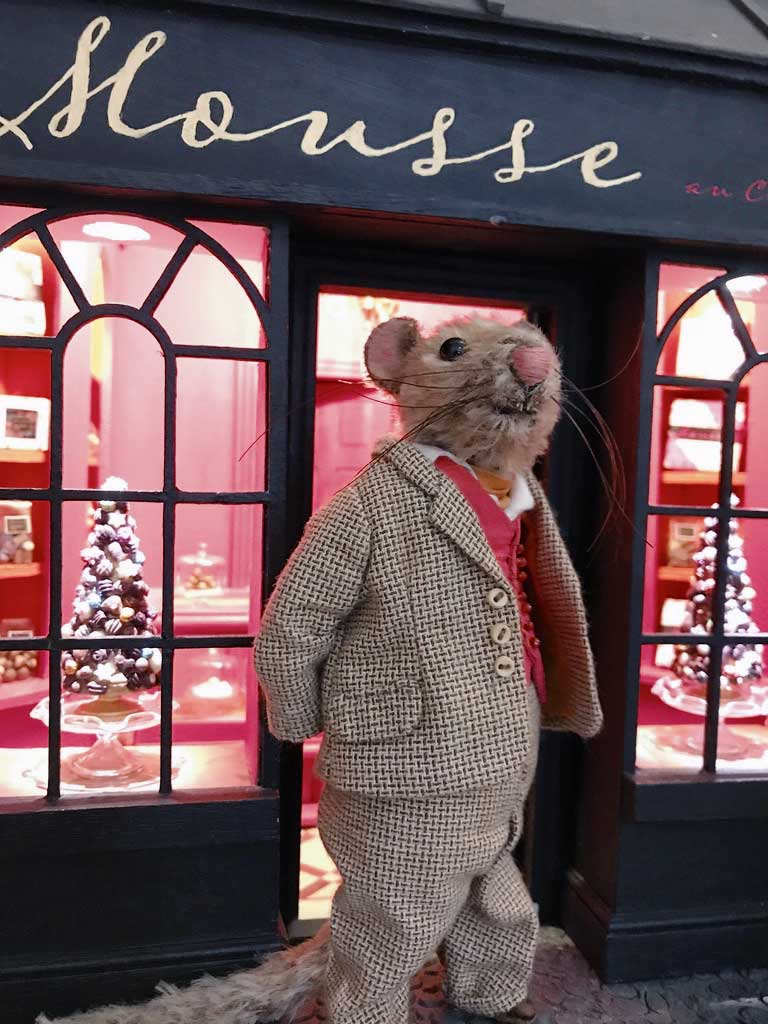Claude the mohair mouse outside his dolls house chocolate shop