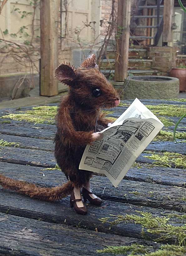 Emma mouse reading a newspaper