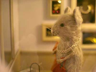 Mouse trying on necklace